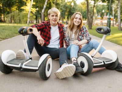 couple-sitting-on-road-with-gyro-board-MSLGQ7C.jpg